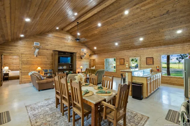 a very nice looking open dining room with furniture window and wooden floor