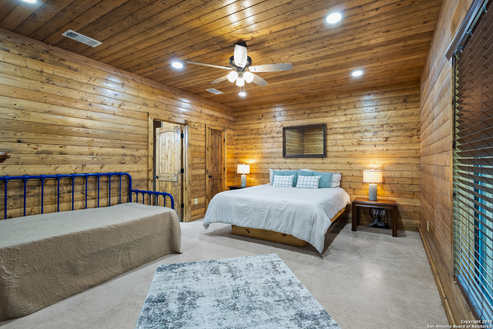 370 Johnny Seibert Rio Frio, TX 78873 - Photo 15 of 40 a bedroom with three beds and a ceiling fan