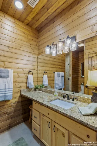 a bathroom with double sink and a mirror
