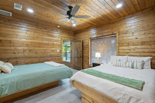 a bedroom with a bed and a ceiling fan