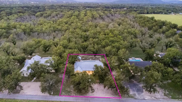an aerial view of a house with a yard