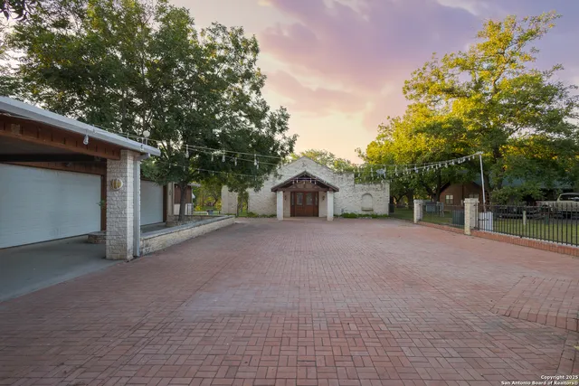 a view of a house with a yard and garage