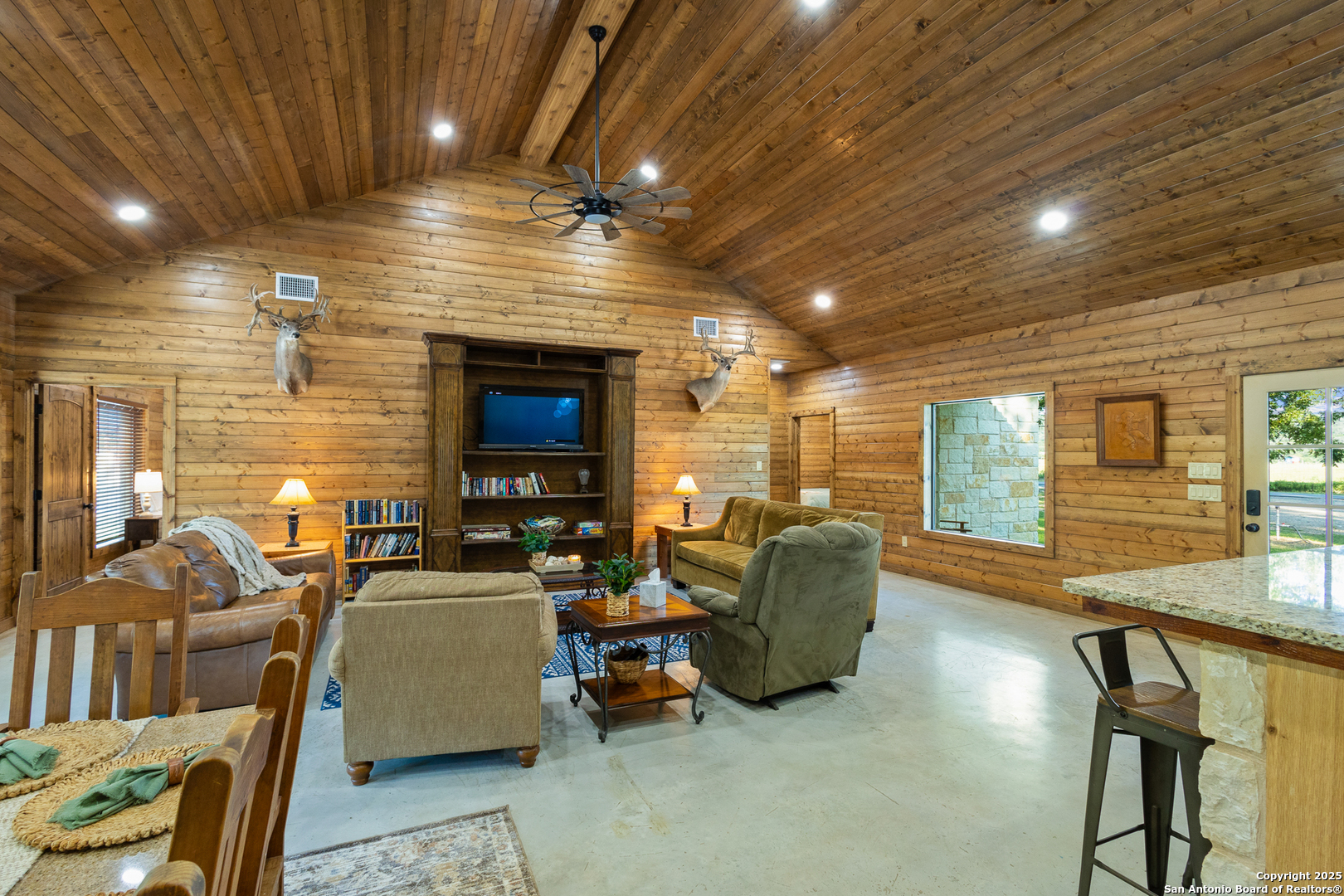 370 Johnny Seibert Rio Frio, TX 78873 - Photo 10 of 40 a living room with furniture a fireplace and a projector