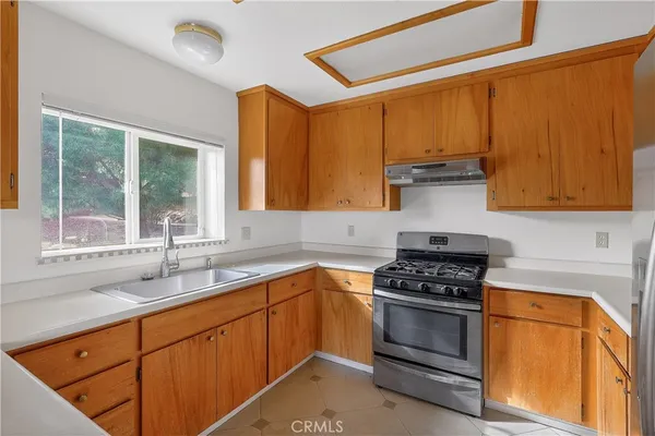a kitchen with stainless steel appliances a stove a sink and a microwave