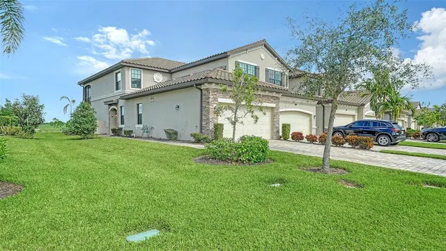 a front view of a house with a garden and plants