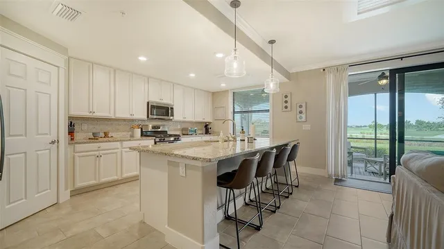 a bedroom with furniture and a large window