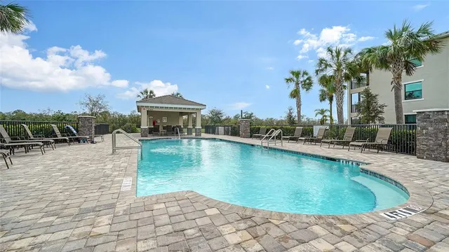 a front view of a house with swimming pool and porch