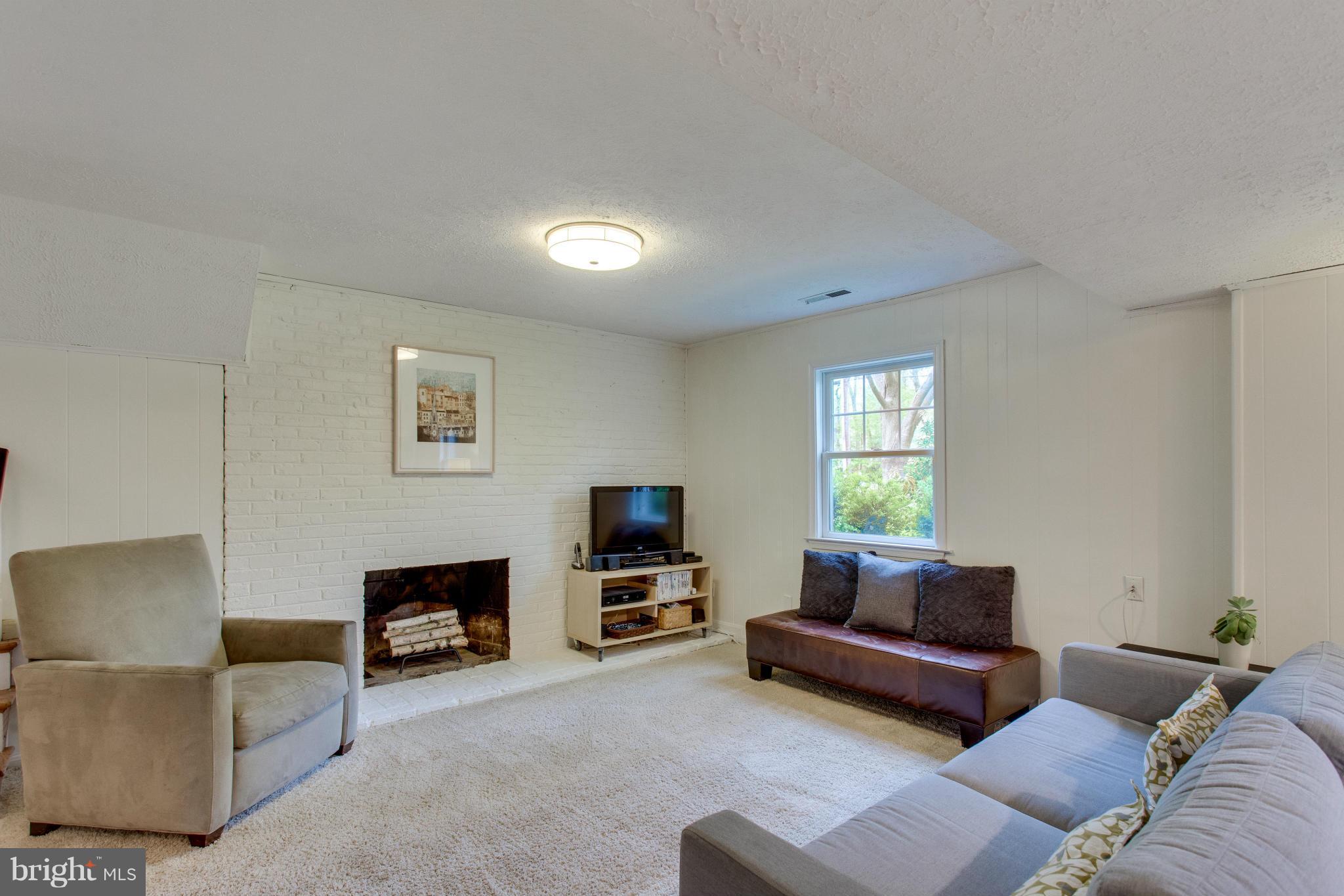 8735 Fort Hunt Road Alexandria, VA 22308 - Photo 19 of 30 Wood-burning fireplace in lower-level family room