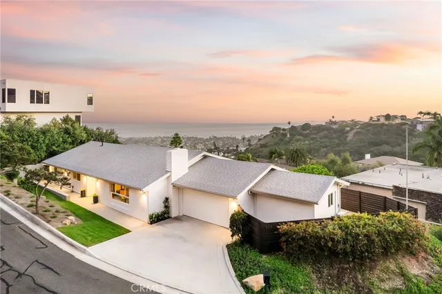 an aerial view of multiple houses with a big yard