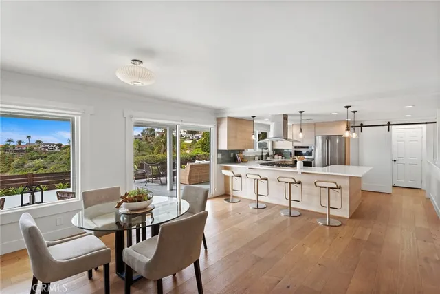 a large kitchen with a table and chairs