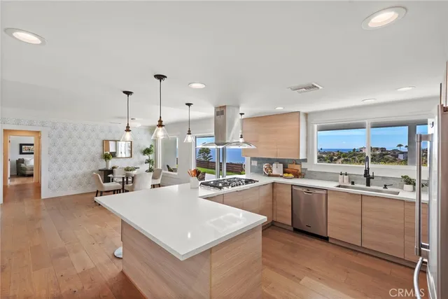 a kitchen with stainless steel appliances a sink a stove and a refrigerator