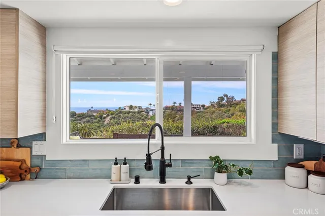 a large white kitchen with a stove a sink a refrigerator and a counter top space