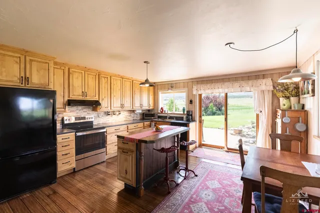 a kitchen with stainless steel appliances granite countertop a stove and a refrigerator
