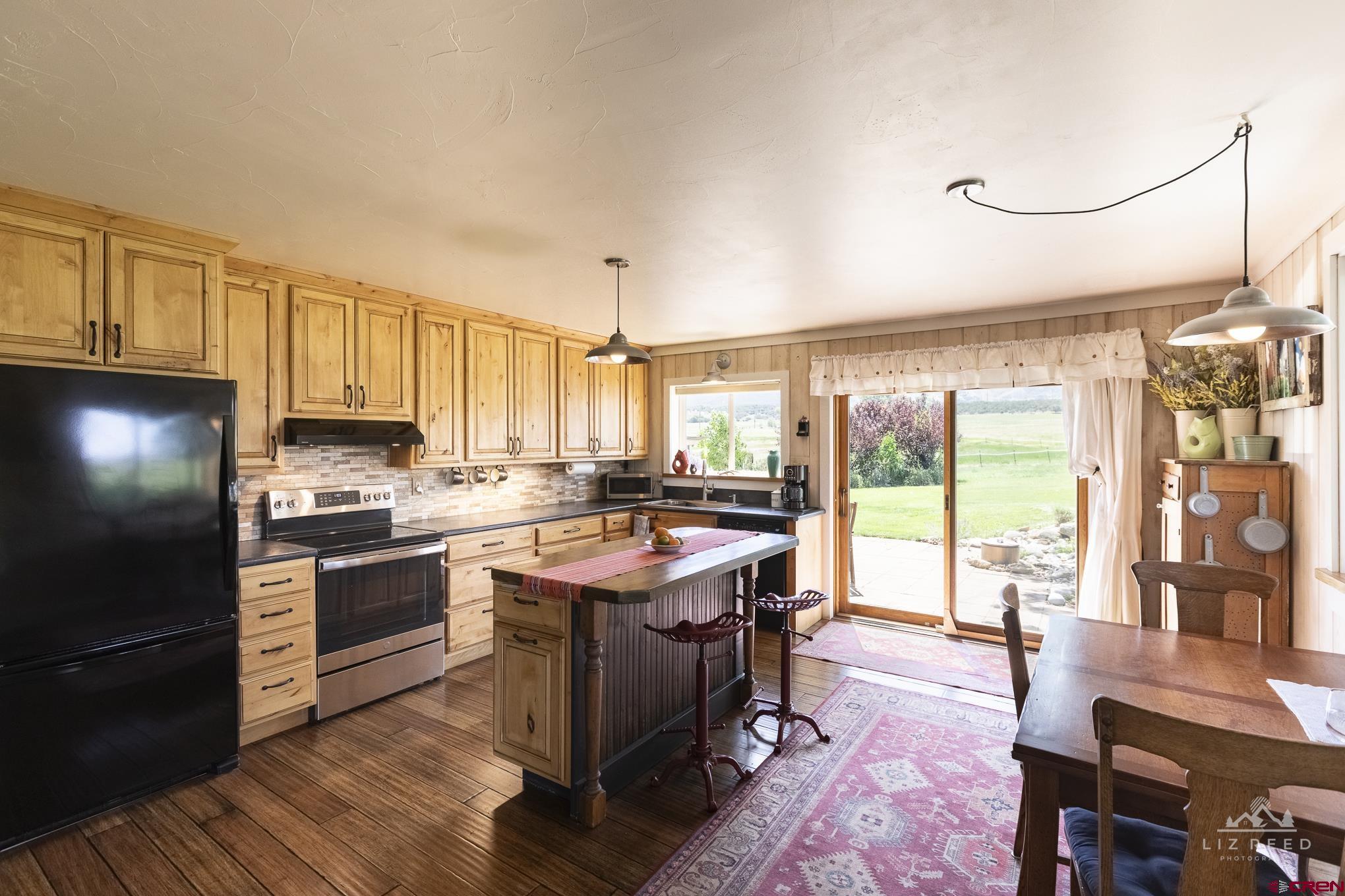 11450 Crawford Road Paonia, CO 81428 - Photo 14 of 41 a kitchen with stainless steel appliances granite countertop a stove and a refrigerator