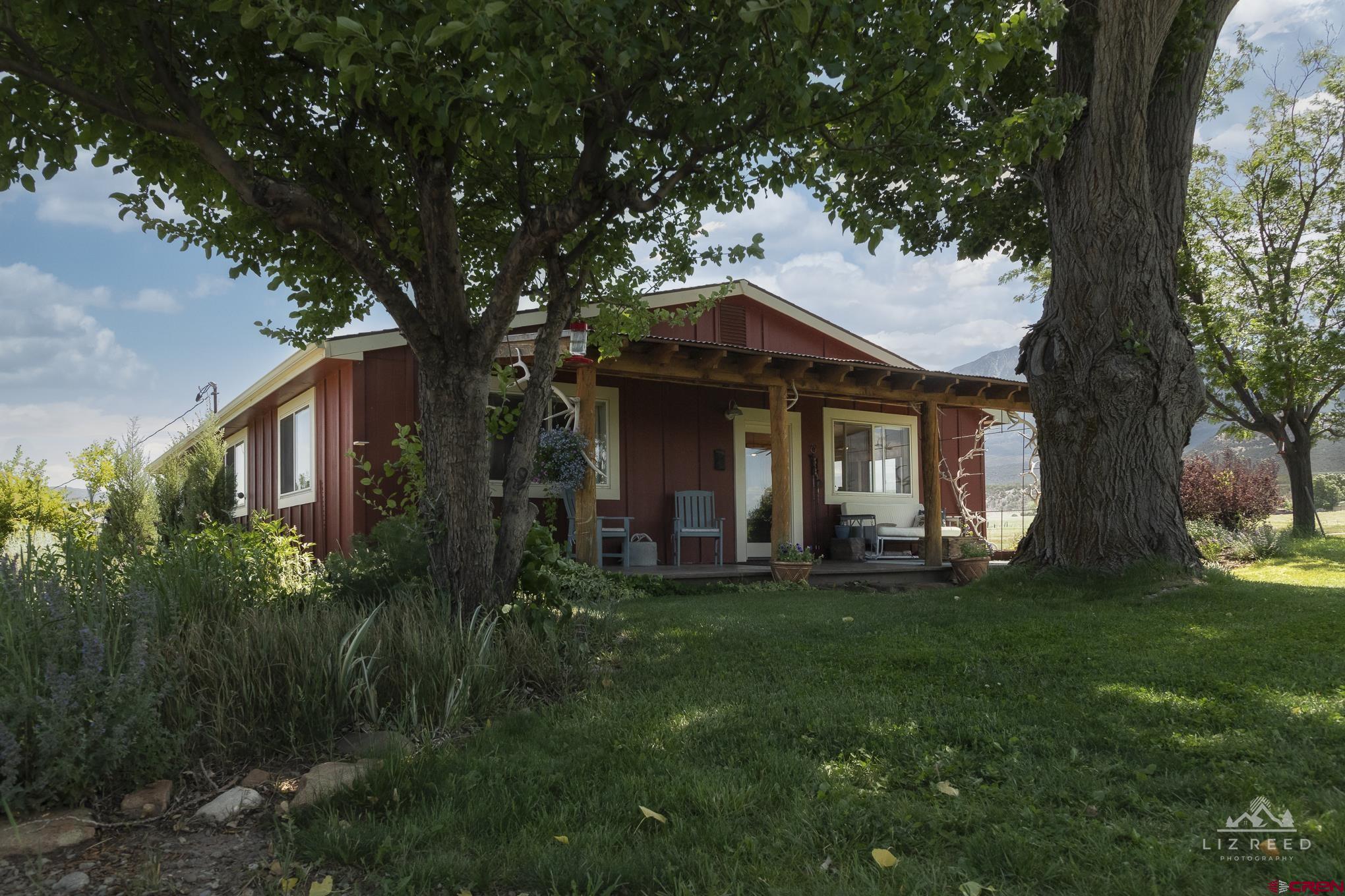11450 Crawford Road Paonia, CO 81428 - Photo 2 of 41 a front view of a house with a garden
