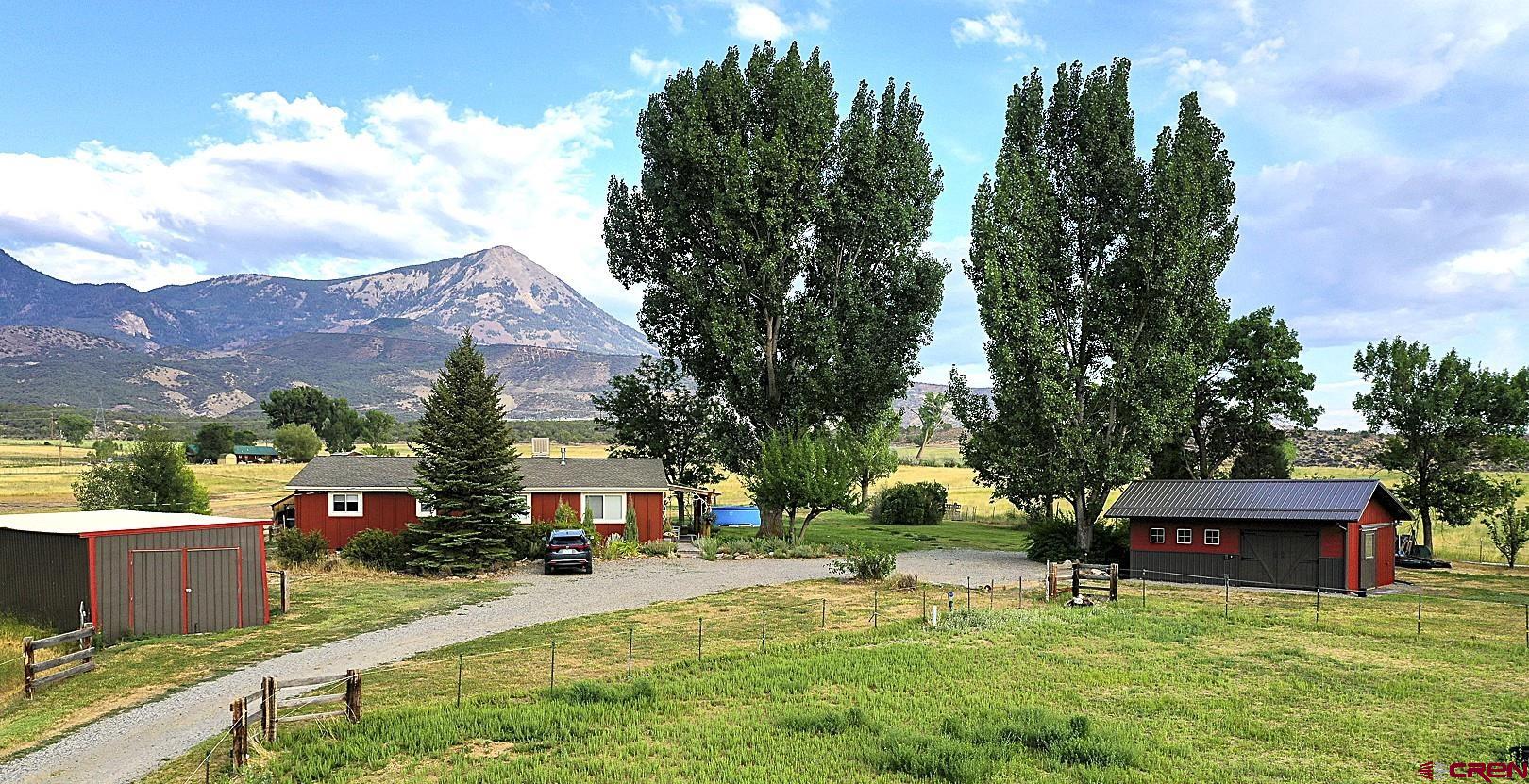 11450 Crawford Road Paonia, CO 81428 - Photo 41 of 41 a front view of a house with a garden and trees