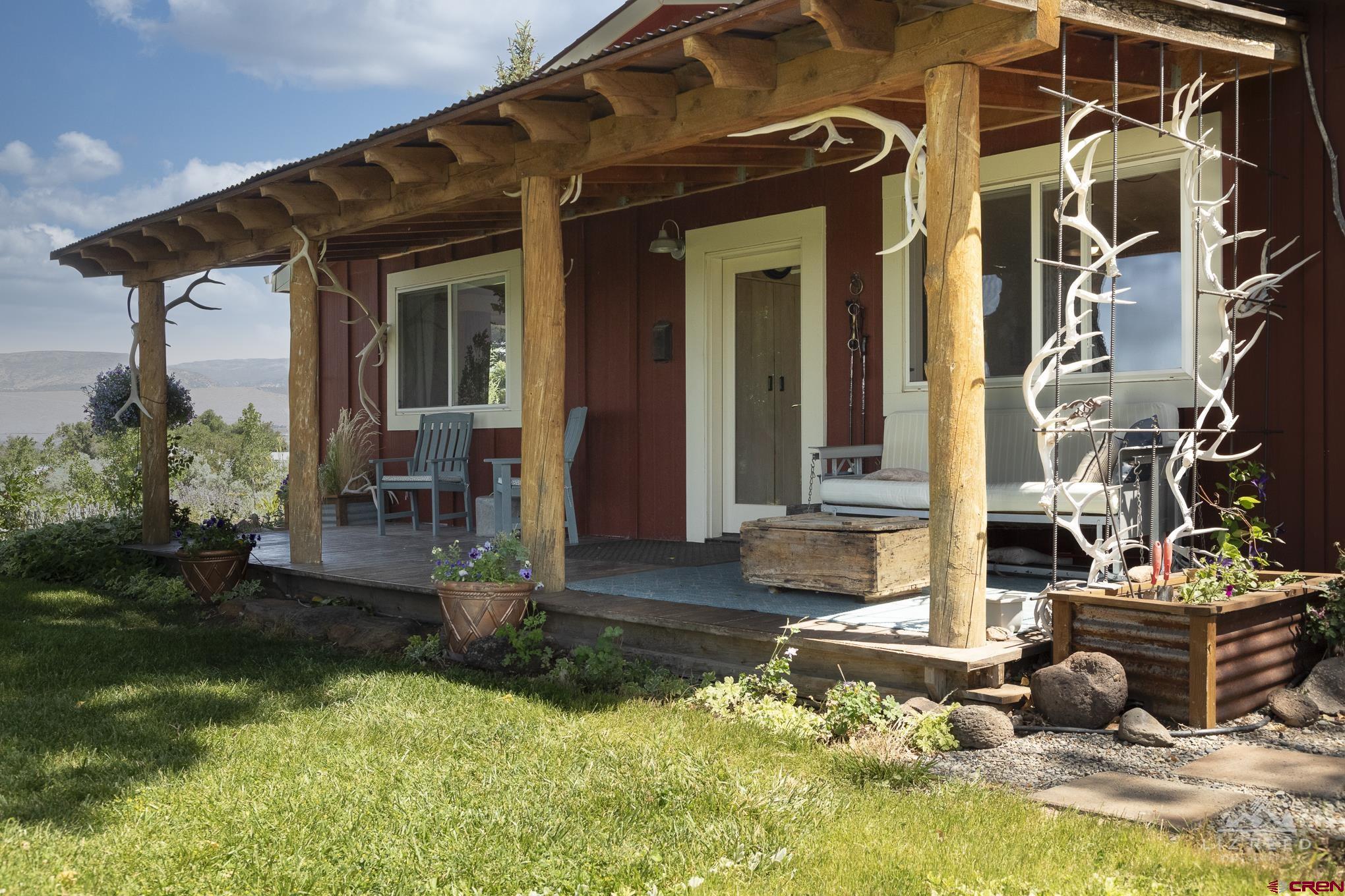 11450 Crawford Road Paonia, CO 81428 - Photo 9 of 41 a front view of a house with garden