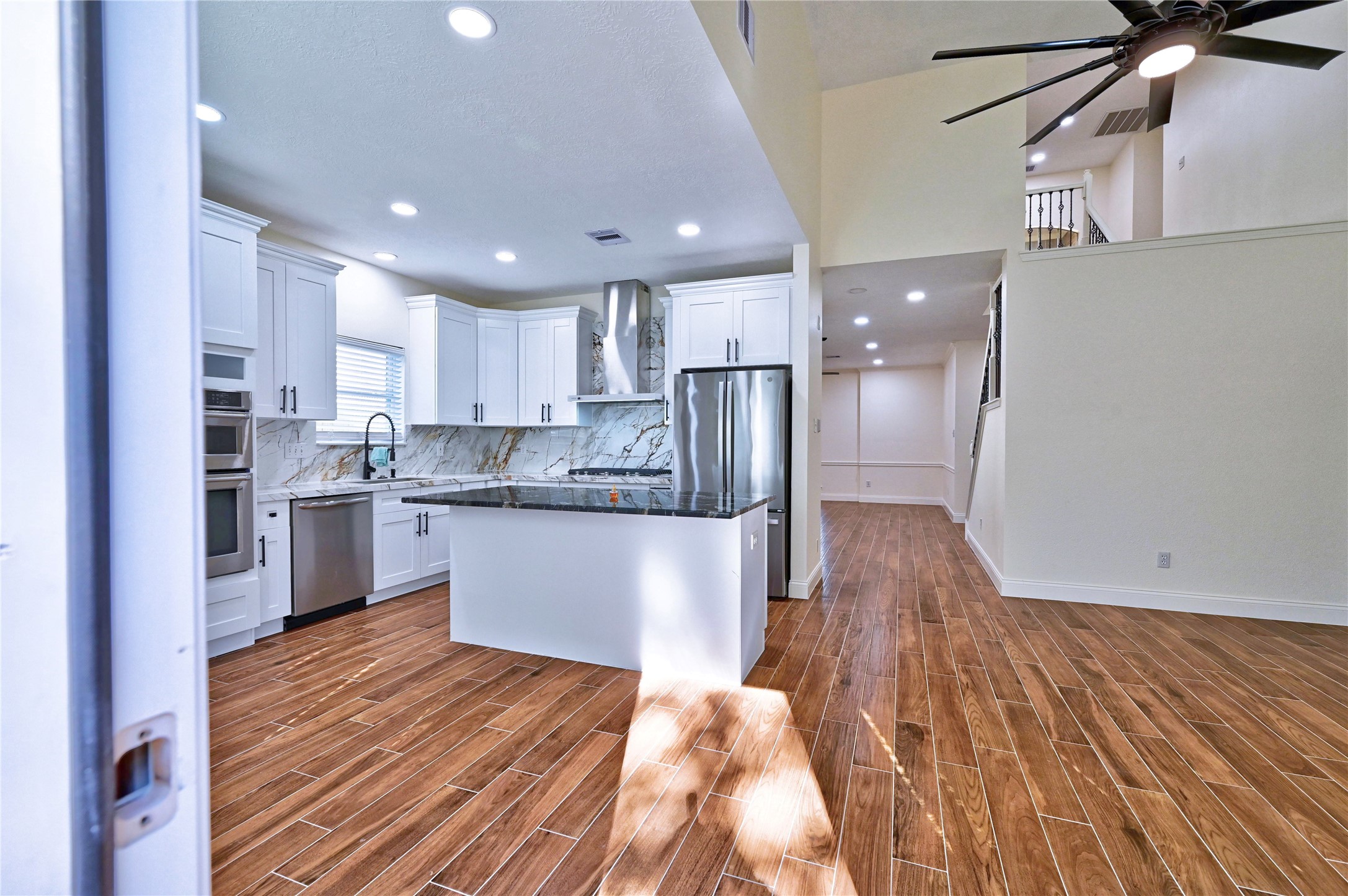 17907 Pelican Way Road Houston, TX 77084 - Photo 16 of 38 a kitchen with stainless steel appliances granite countertop a refrigerator a sink dishwasher a stove and white countertops with wooden floor