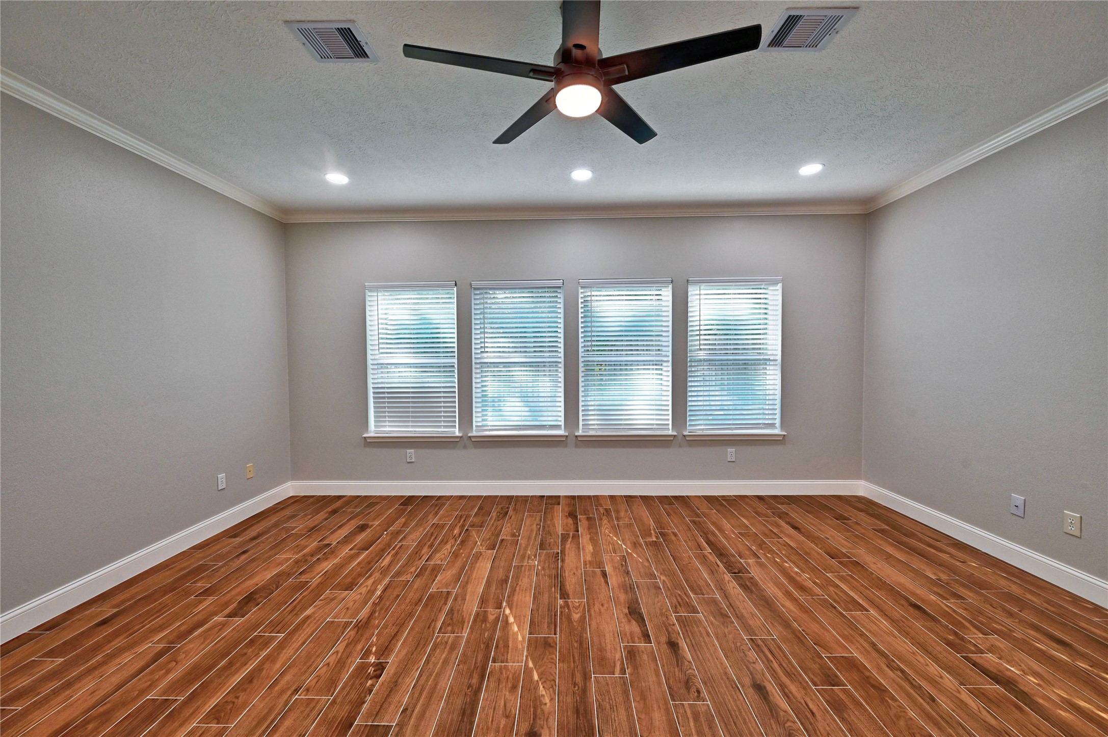 17907 Pelican Way Road Houston, TX 77084 - Photo 18 of 38 a view of an empty room with wooden floor and a window