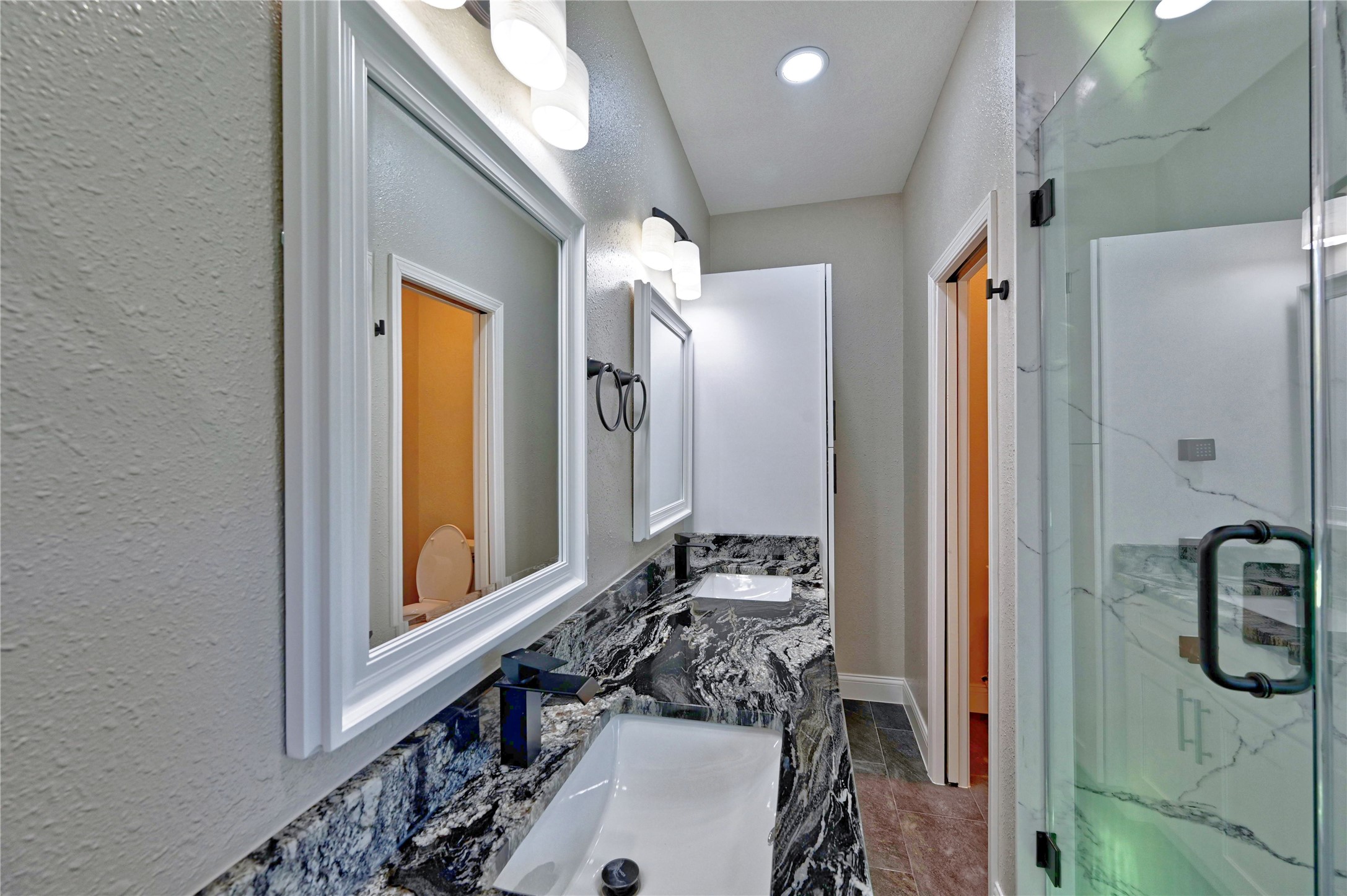 17907 Pelican Way Road Houston, TX 77084 - Photo 23 of 38 a bathroom with a sink a mirror and a shower