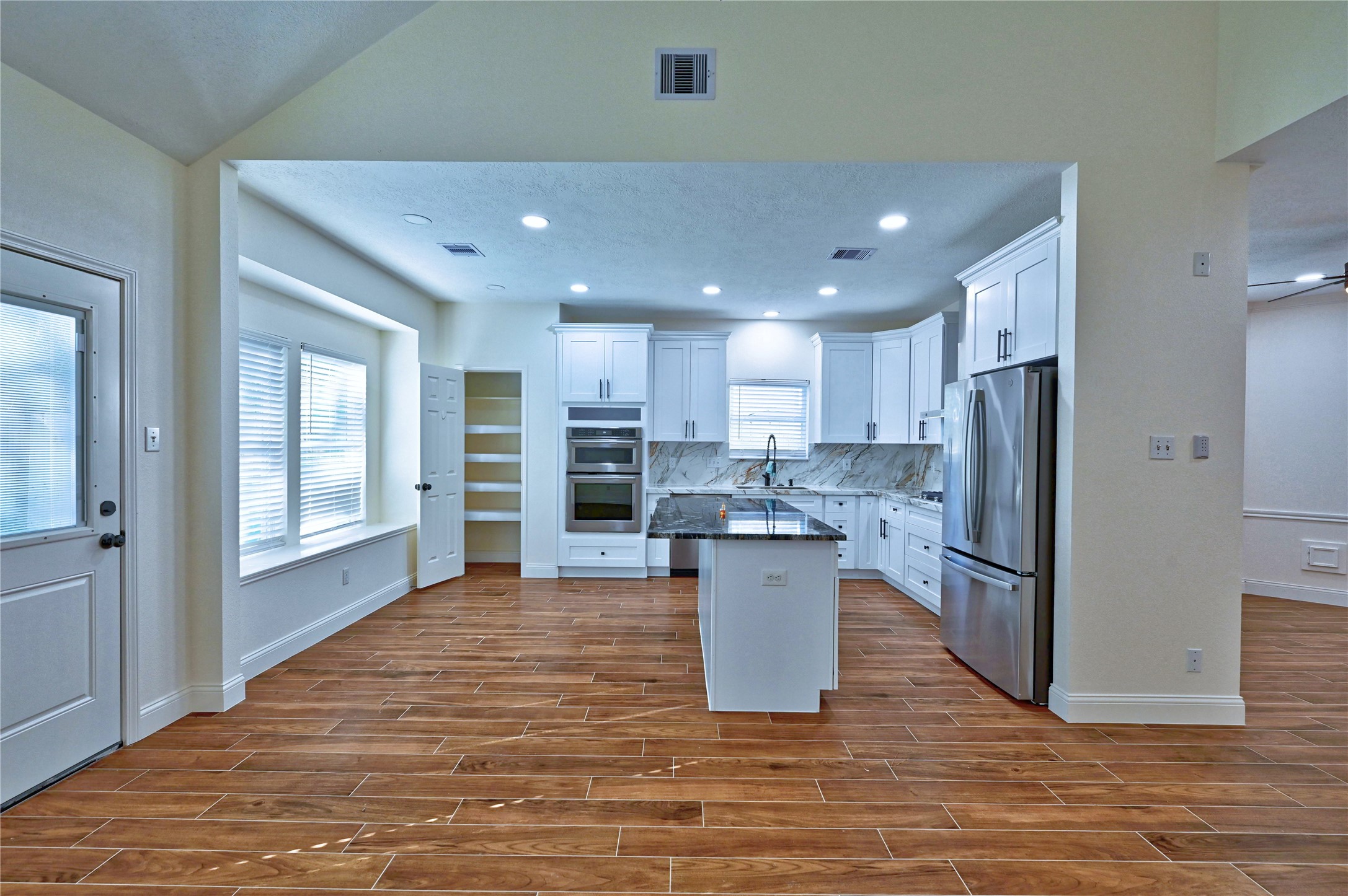 17907 Pelican Way Road Houston, TX 77084 - Photo 9 of 38 a kitchen with stainless steel appliances kitchen island granite countertop a refrigerator and a sink