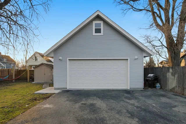 a view of a house with a yard and garage