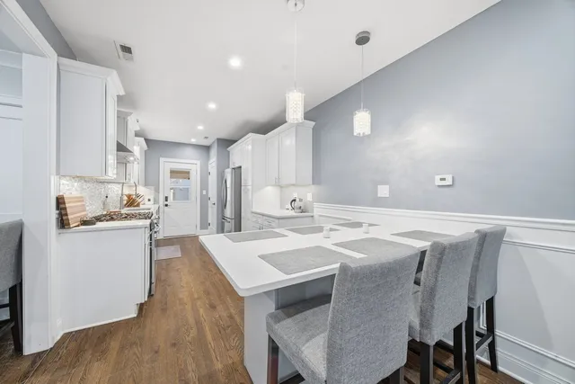 a kitchen with appliances a sink and cabinets