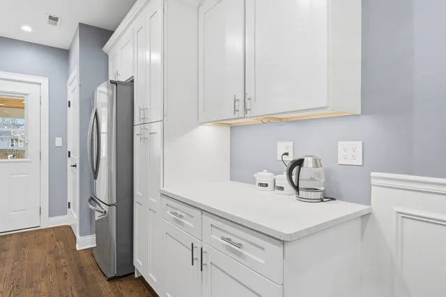 a kitchen with stainless steel appliances white cabinets and a sink