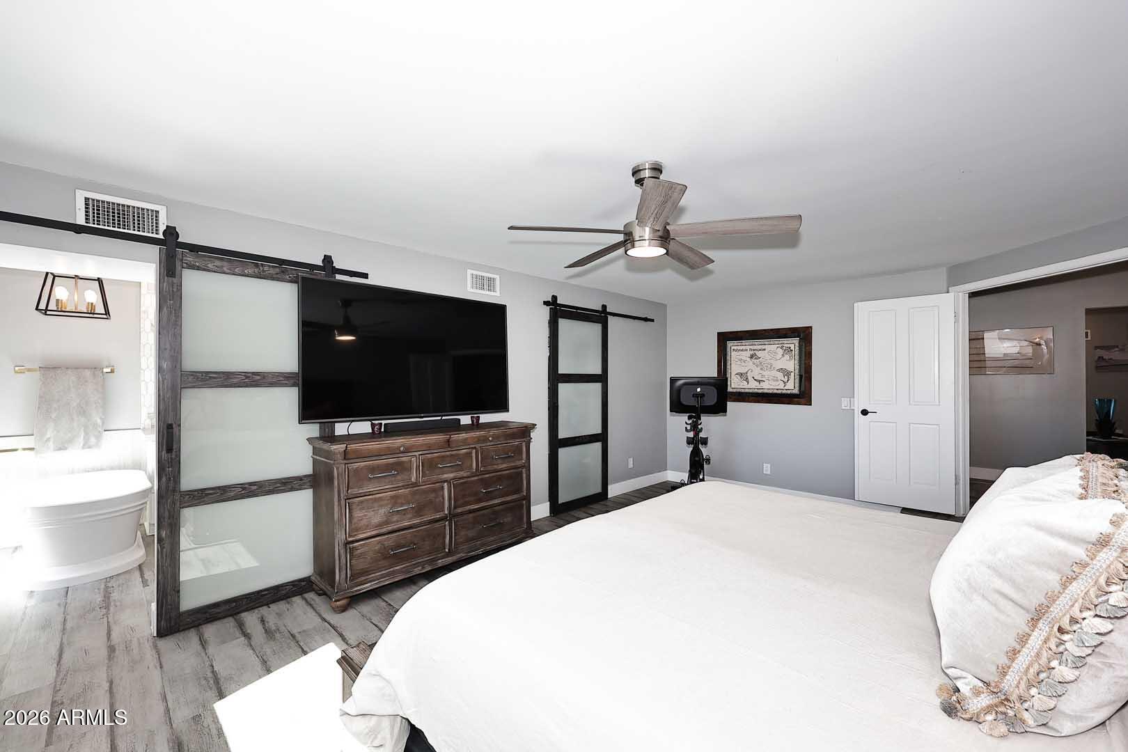 4641 East Mountain View Road Phoenix, AZ 85028 - Photo 14 of 44 a bedroom with a bed and a flat screen tv