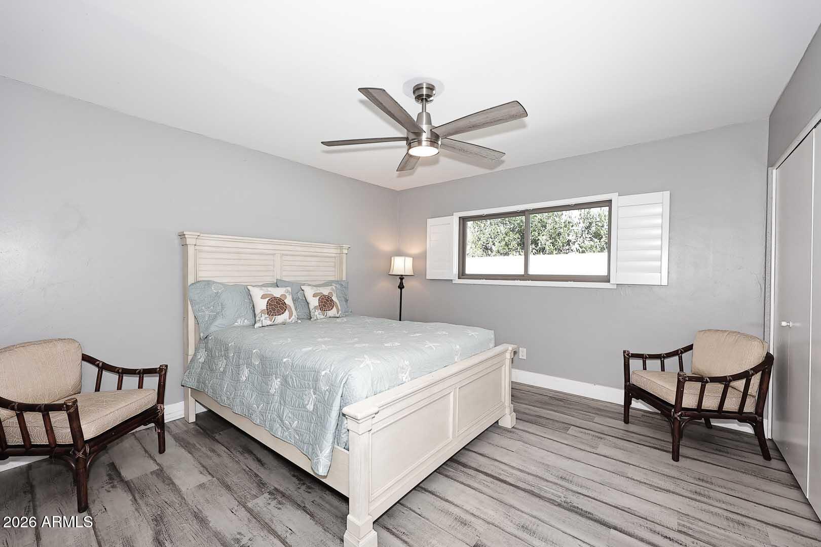 4641 East Mountain View Road Phoenix, AZ 85028 - Photo 19 of 44 a bedroom with a bed a table and chair