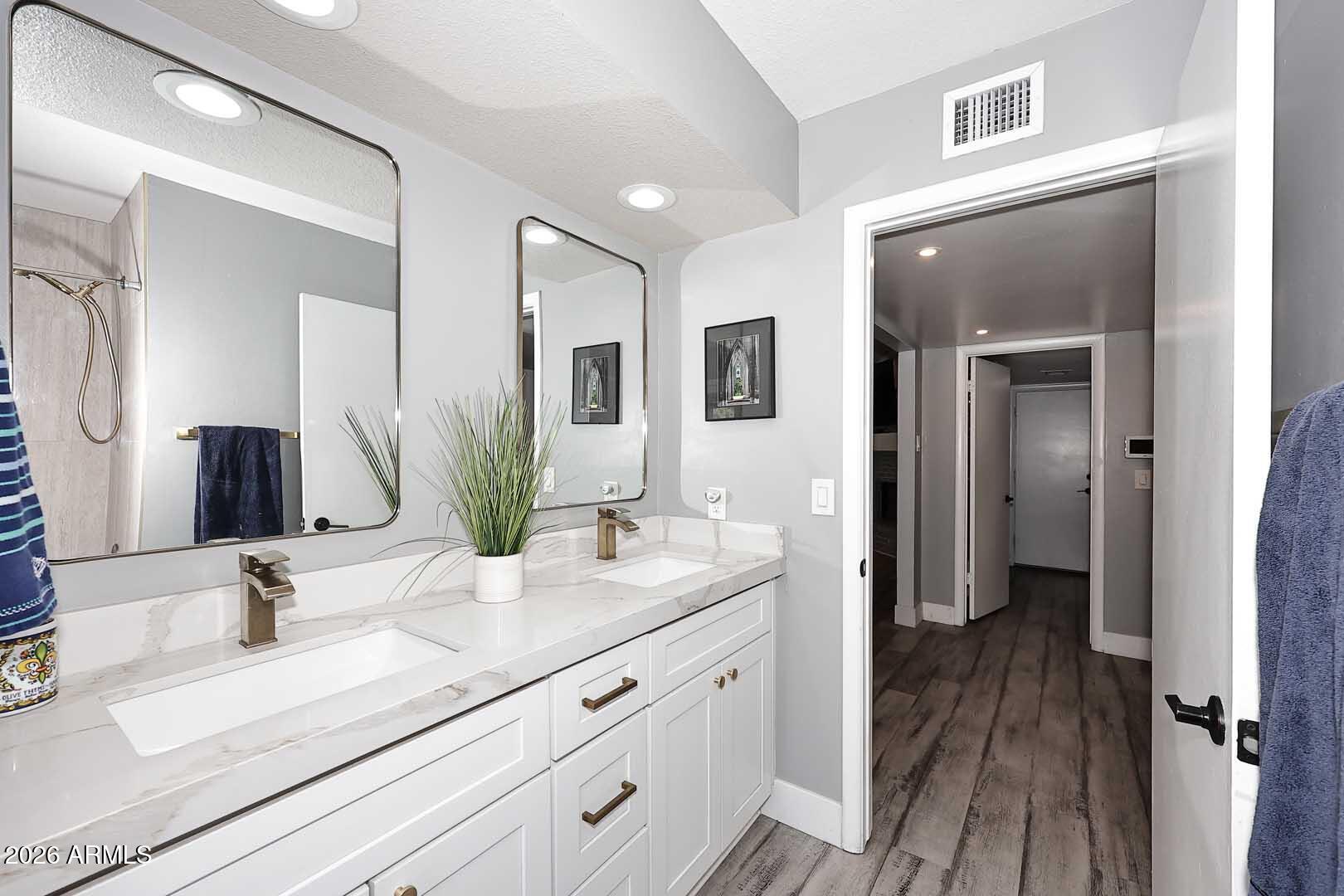 4641 East Mountain View Road Phoenix, AZ 85028 - Photo 20 of 44 a bathroom with a granite countertop sink mirror and vanity
