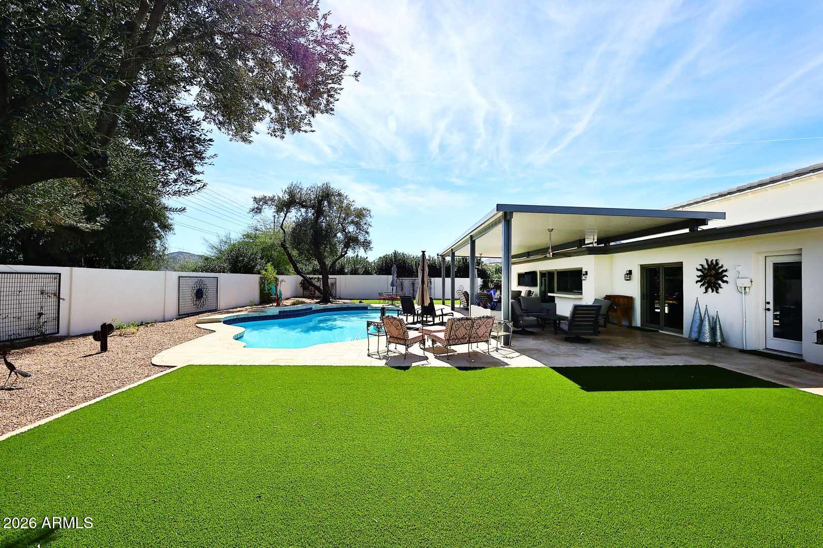 4641 East Mountain View Road Phoenix, AZ 85028 - Photo 24 of 44 a view of a house with swimming pool and sitting area