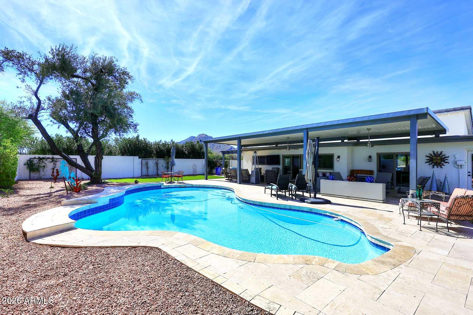 4641 East Mountain View Road Phoenix, AZ 85028 - Photo 25 of 44 a view of a swimming pool with chairs