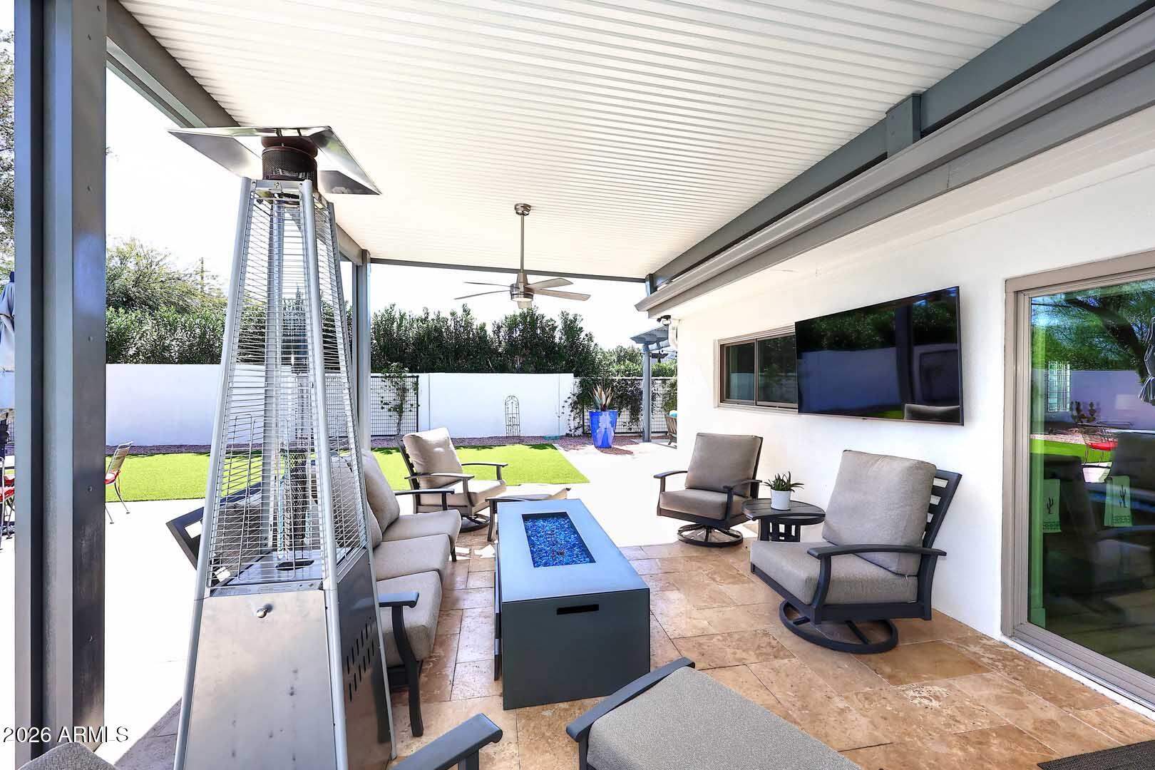 4641 East Mountain View Road Phoenix, AZ 85028 - Photo 33 of 44 a view of a patio with couches chairs and potted plants