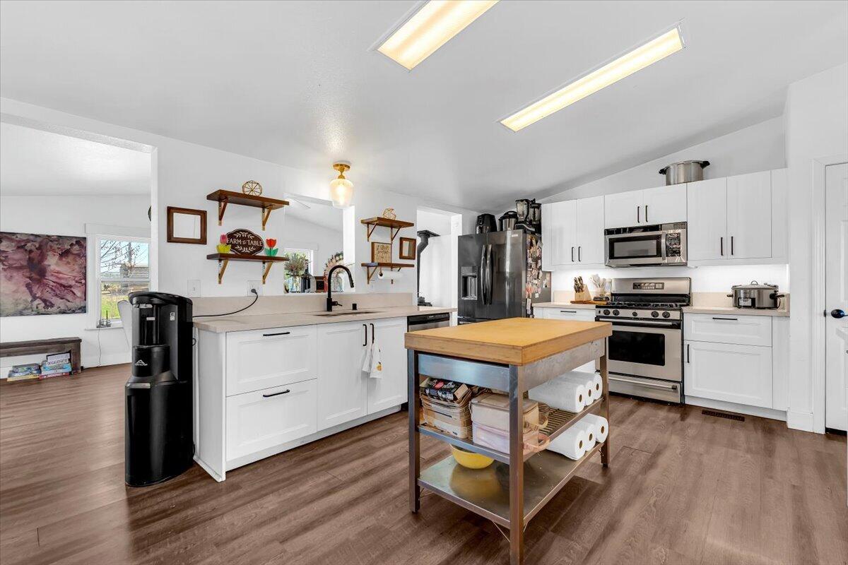 23504 Dersch Road Anderson, CA 96007 - Photo 17 of 54 a kitchen with a stove a sink and a refrigerator