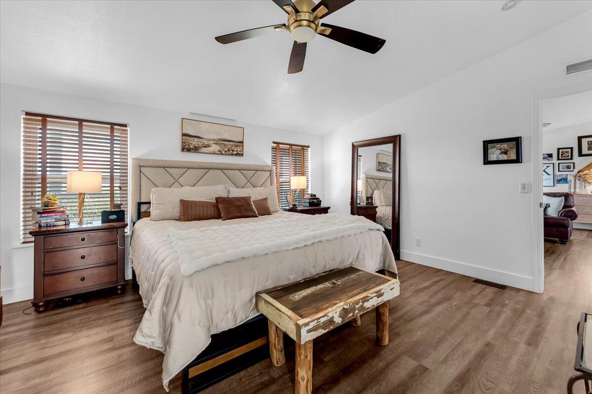 23504 Dersch Road Anderson, CA 96007 - Photo 22 of 54 a bedroom with a bed and wooden floor