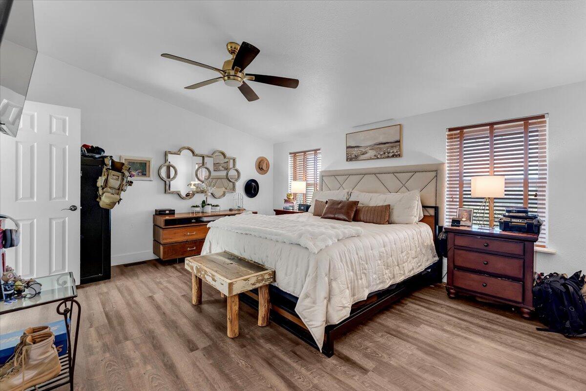 23504 Dersch Road Anderson, CA 96007 - Photo 23 of 54 a bedroom with a bed and a chandelier