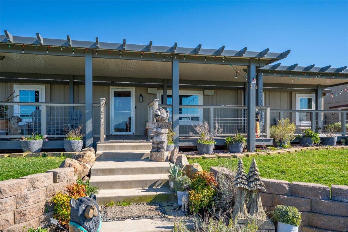 23504 Dersch Road Anderson, CA 96007 - Photo 52 of 54 a view of a house with sitting area and garden