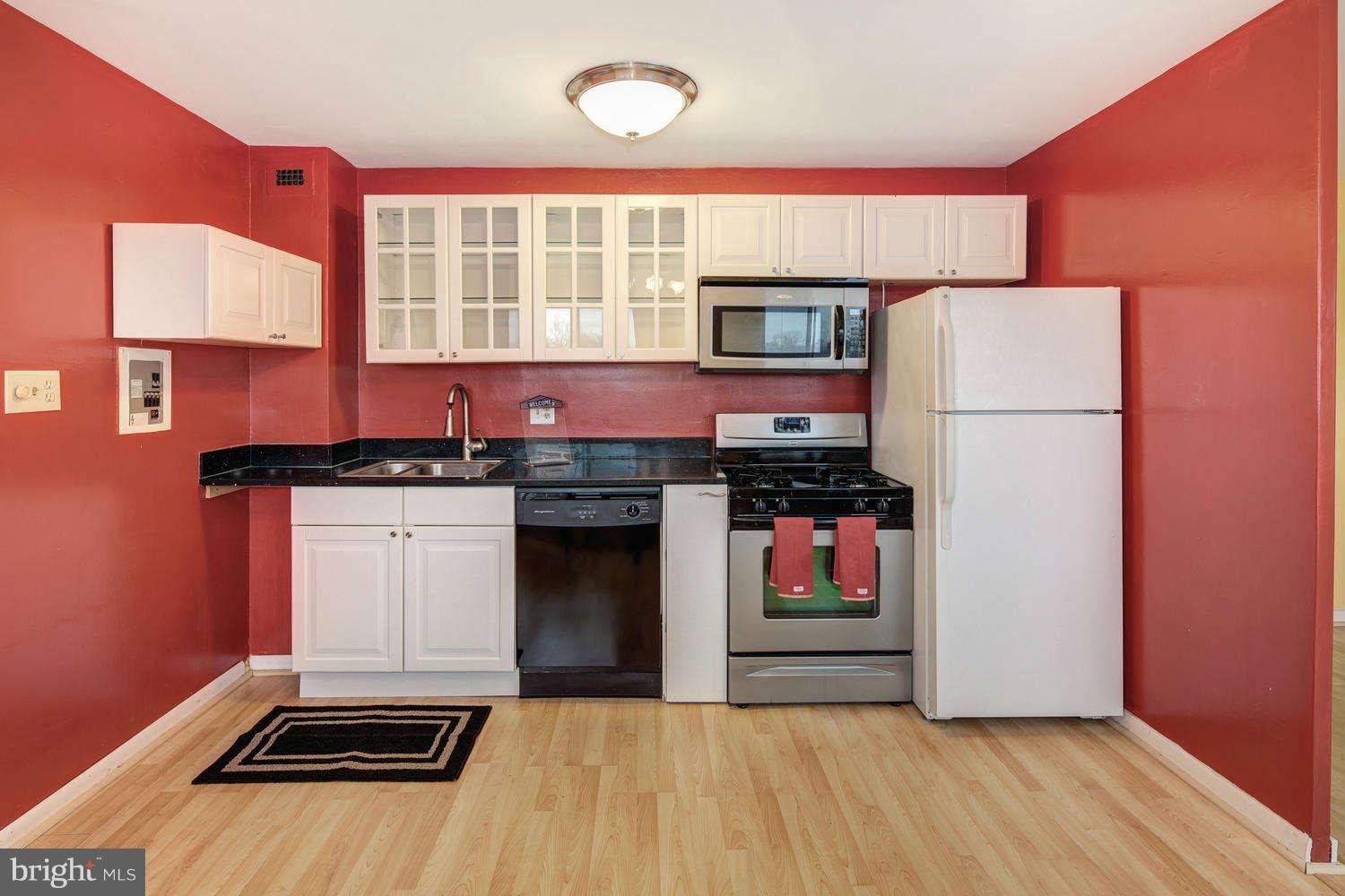 a kitchen with a refrigerator and a stove