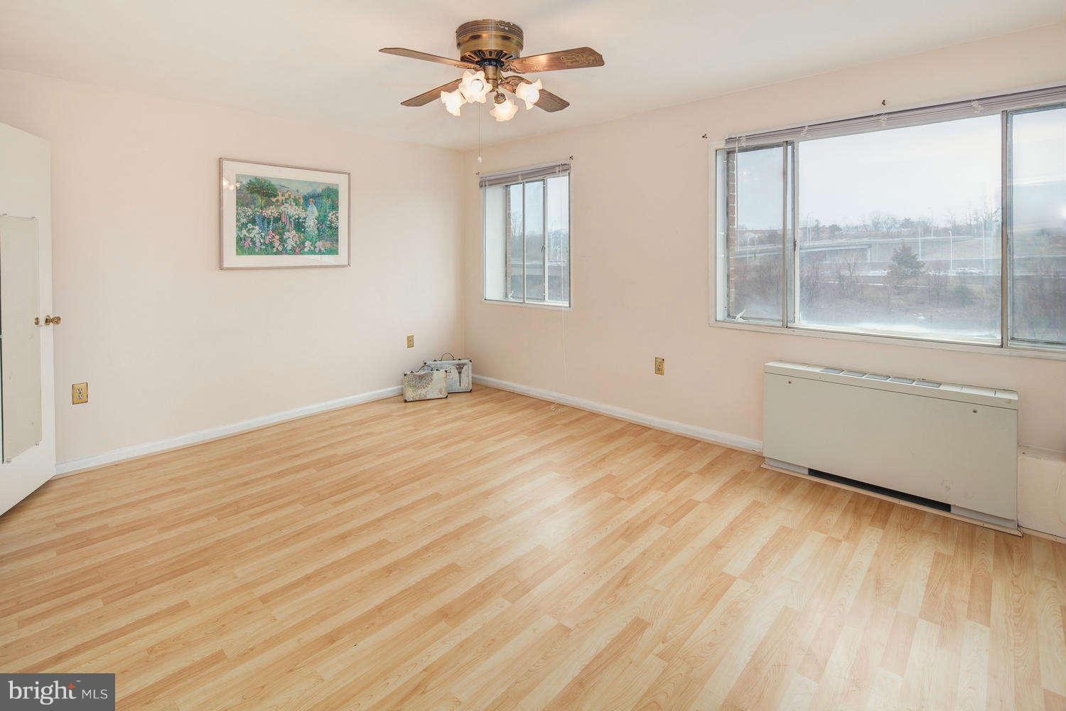 1300 South Arlington Ridge Road, Unit 304 Arlington, VA 22202 - Photo 12 of 19 a view of empty room with wooden floor and fan