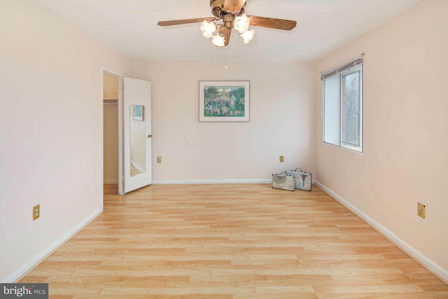 1300 South Arlington Ridge Road, Unit 304 Arlington, VA 22202 - Photo 13 of 19 a view of an empty room with wooden floor and a window