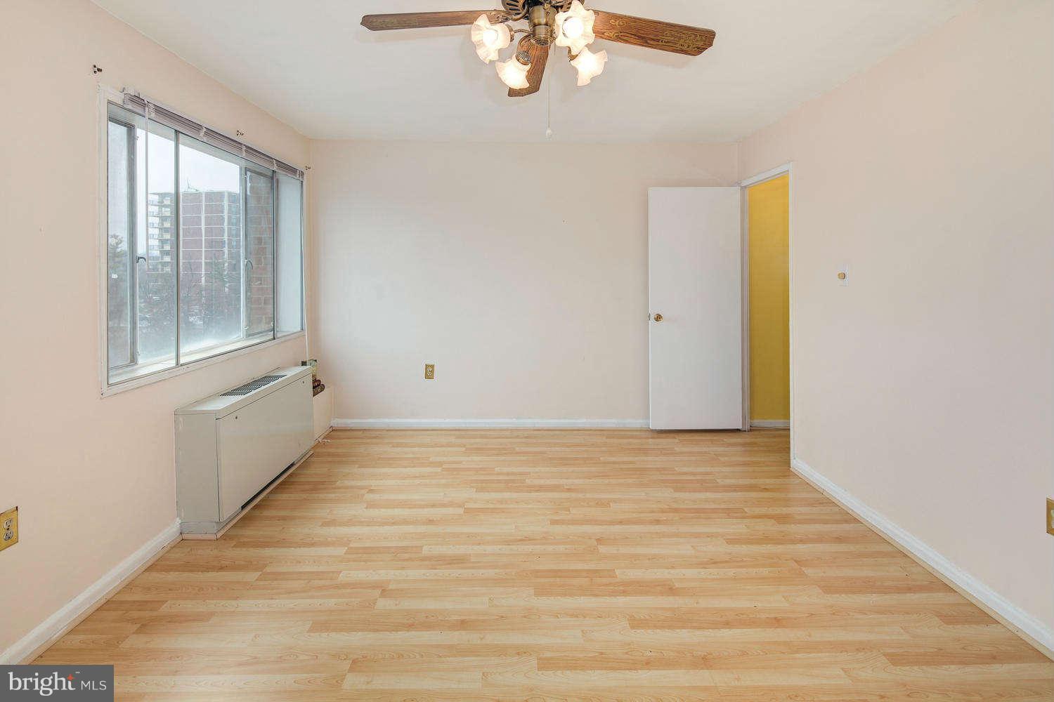 1300 South Arlington Ridge Road, Unit 304 Arlington, VA 22202 - Photo 14 of 19 a view of an empty room with wooden floor and a window