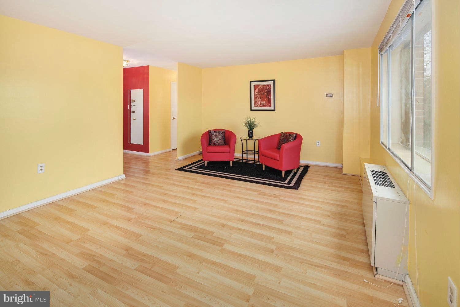 1300 South Arlington Ridge Road, Unit 304 Arlington, VA 22202 - Photo 5 of 19 a bedroom with a bed and wooden floor