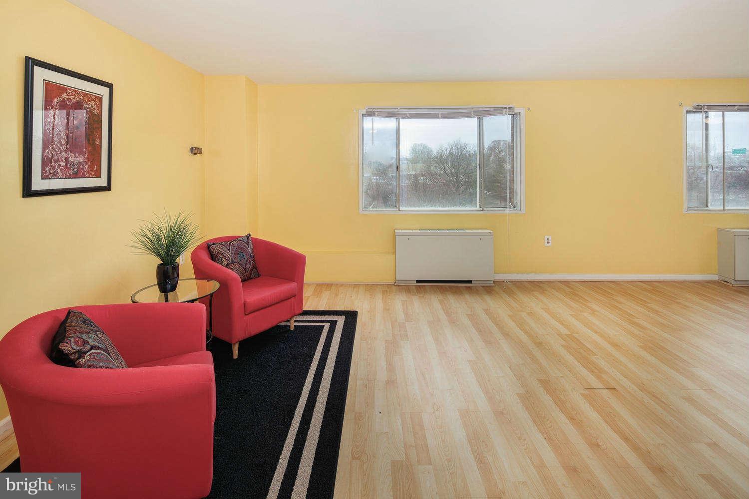 1300 South Arlington Ridge Road, Unit 304 Arlington, VA 22202 - Photo 6 of 19 a living room with furniture and a window