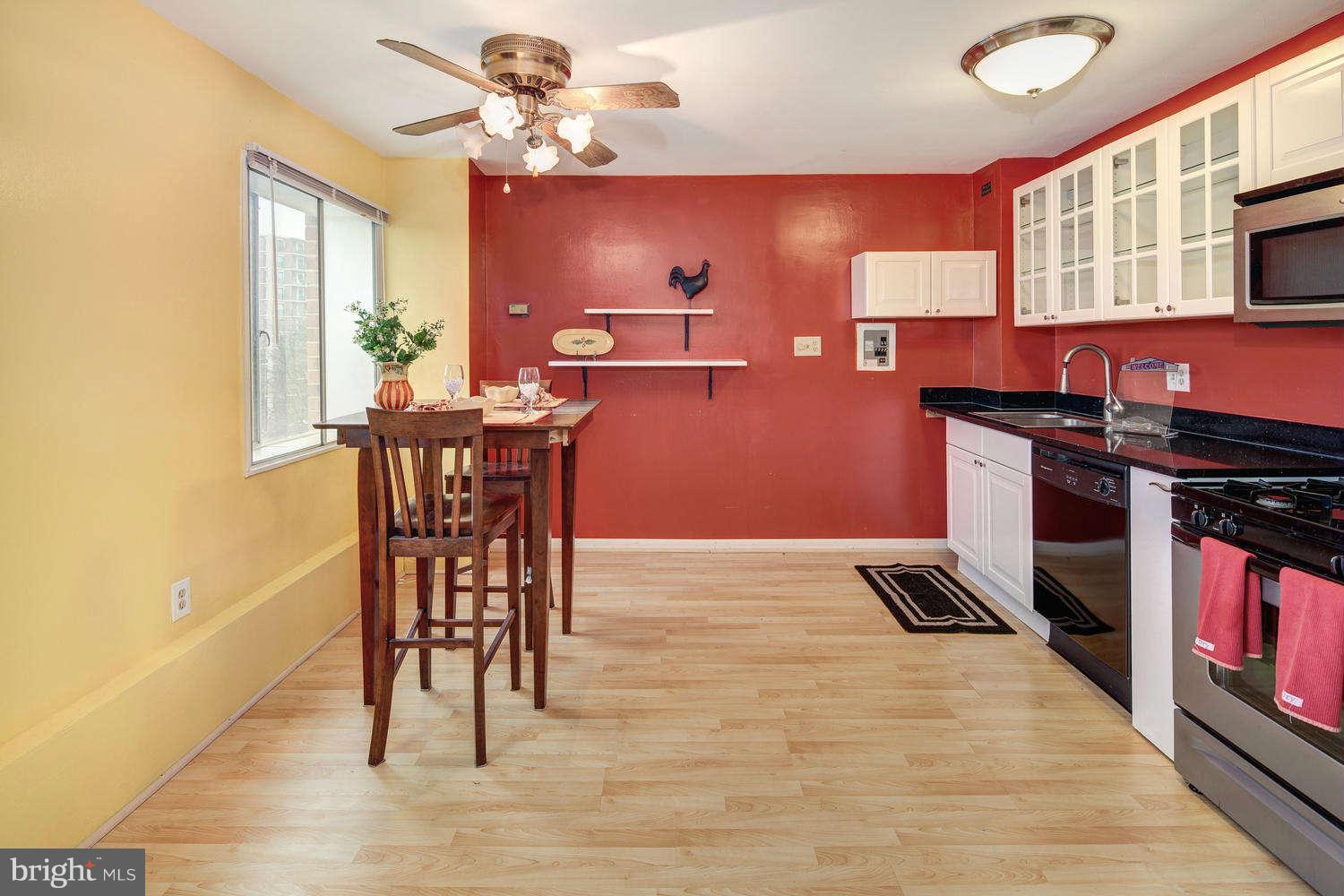 1300 South Arlington Ridge Road, Unit 304 Arlington, VA 22202 - Photo 8 of 19 a view of a dining room with furniture a chandelier and wooden floor