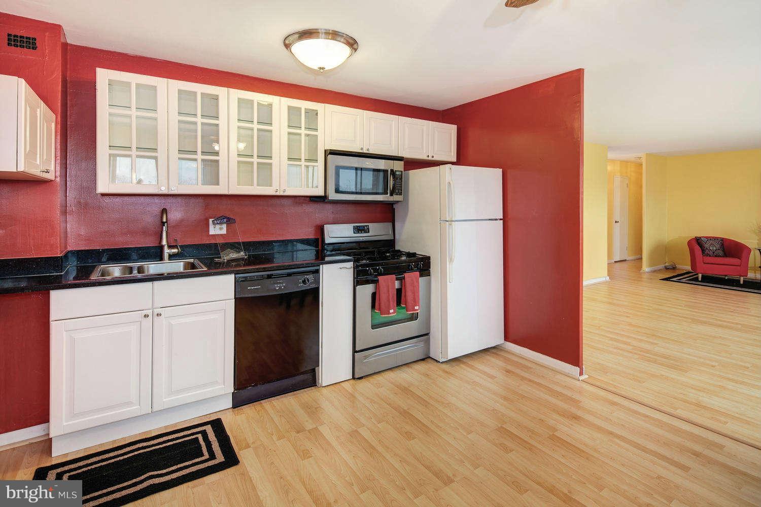 1300 South Arlington Ridge Road, Unit 304 Arlington, VA 22202 - Photo 9 of 19 a kitchen with stainless steel appliances granite countertop a refrigerator a stove and a sink
