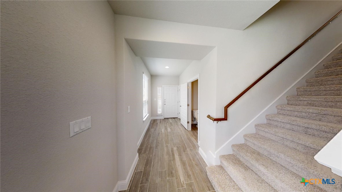 116 Hidden Branch Cove Maxwell, TX 78656 - Photo 7 of 23 a view of a hallway with wooden floor and staircase