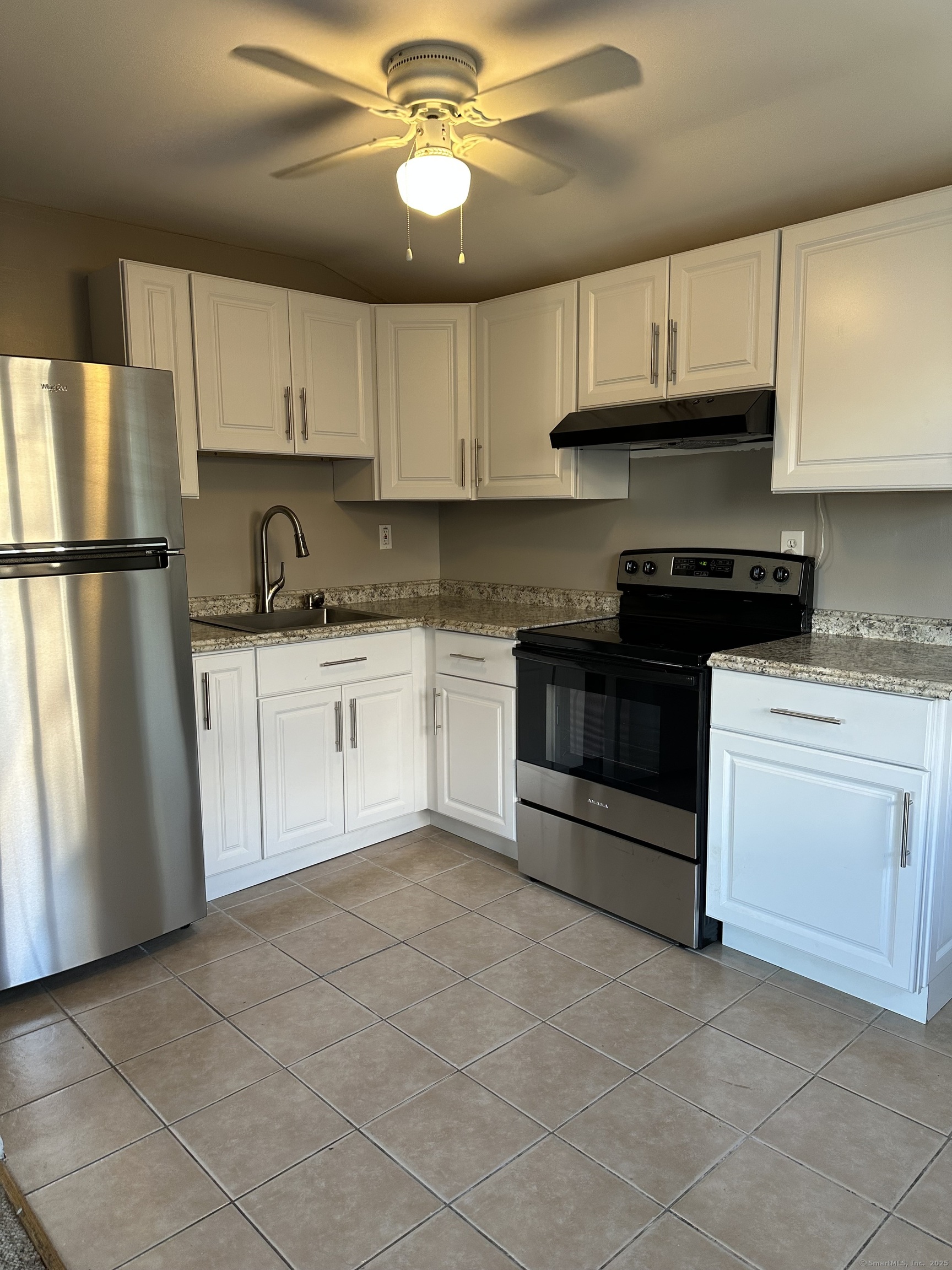 466 Merritt Street Bridgeport, CT 06606 - Photo 2 of 12 a kitchen with stainless steel appliances granite countertop a stove a sink and a refrigerator