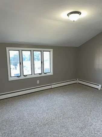 an empty room with a empty space and windows