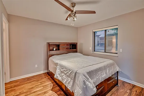 a bedroom with a bed and a chandelier